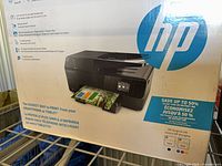 Front of sealed retail box showing HP OfficeJet Pro 6830 printer image and features