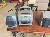 Front view showing main unit and two speakers