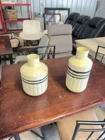 Both vases on table showing overall design and size