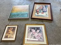 All four framed artworks laid on floor