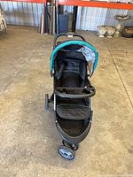 Front view showing stroller seat, child tray, canopy, wheels