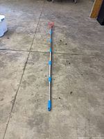 Full view of extended fruit picker on concrete floor