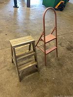 Both folding step ladders standing side by side