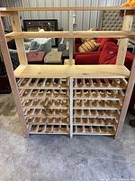 Front view of two peg-style wine rack panels set into framing