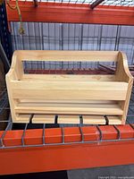 Front view showing five pegs and upper rail