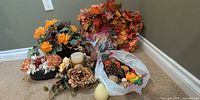Group shot of all items including wreath, faux florals, candles, seed pods