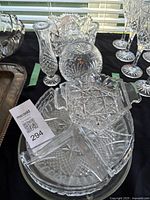 Group of cut glass items including vases, bowls, snack plate with dividers