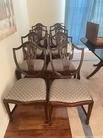 Front view of all eight chairs showing style and upholstery