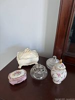 Group of five decor pieces on dresser