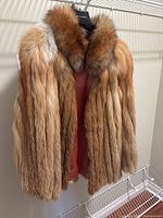 Front view of multi-colour light brown fur coat showing texture and lining