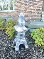 Full view of resin pagoda lantern in garden bed