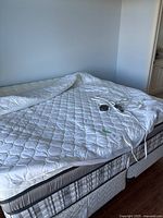 King size heated mattress pad spread on mattress