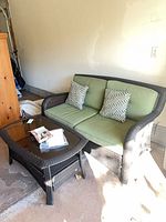 Loveseat with cushions, coffee table visible