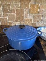 Dutch oven on stovetop showing full exterior and lid