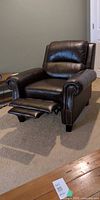 Front view of brown faux leather recliner fully extended