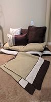 Comforter, cushions and shams grouped together