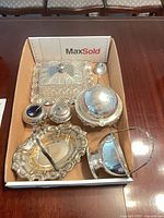 Overview of all silver-plated items in tray