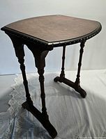 Overall view of antique wood side table front angle
