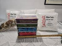 Craft cabinet, five pillow forms, bolster pillow; ruler for scale