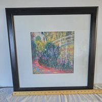 Full view of framed garden scene print with ruler for scale