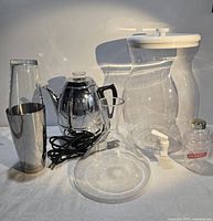 Group shot of all items including dispenser, percolator, shakers and decanter