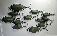 Full view of metal fish wall decor showing shape and color