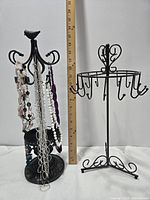 Both metal jewelry stands side by side with necklaces hanging, ruler for scale
