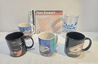 All five items group shot: four mugs and sealed mousepad