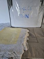 yellow tablecloth with lace over brown tablecloth