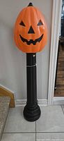 Full view of jack-o-lantern on pole