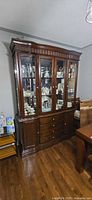 front view of stained wood china cabinet with buffet base