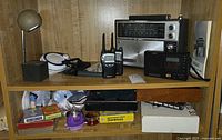 Shelf with radios, walkie-talkies, desk lamp, games, toys