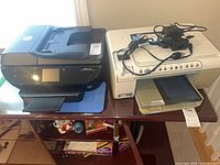 Both printers side by side on shelf