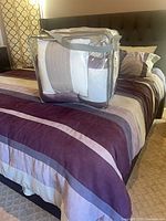 Full view of comforter on king bed with storage bag