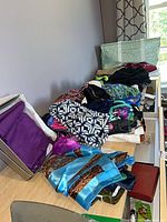 Overview of piled swimsuits, bras and swim shoes on shelf