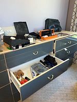 Top of dresser with watches, watch boxes, briefcase