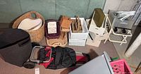 Full view of assorted baskets, bins, drawers, cart and duffel