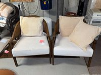 front view of both wooden lounge chairs with cushions