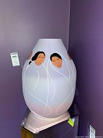 Front view of pastel lavender R.C. Gorman vase showing two stylized women figures