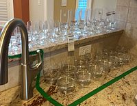 overview of full assortment of clear crystal glasses on countertop