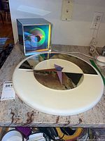 Wall clock and Prisma cube clock on countertop