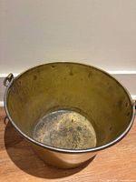 Top view of brass bucket interior showing patina and ring handles