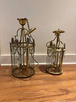 Both brass lantern fixtures side by side on floor