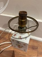 Square ceramic lamp base with floral motifs and brass socket