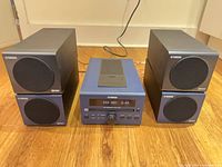 Receiver flanked by four speakers on floor