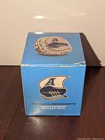 Blue presentation box front with Argonauts logo, replica ring resting on top