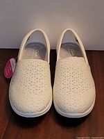 Front view of both shoes showing perforated uppers and tag
