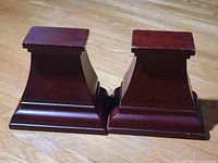 pair of wooden pedestal wall shelves front view