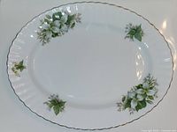 Top view of the Royal Albert Trillium oval platter showing floral pattern and gold-edged scalloped rim.