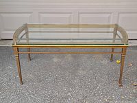 Full front view of table showing glass top and gold frame